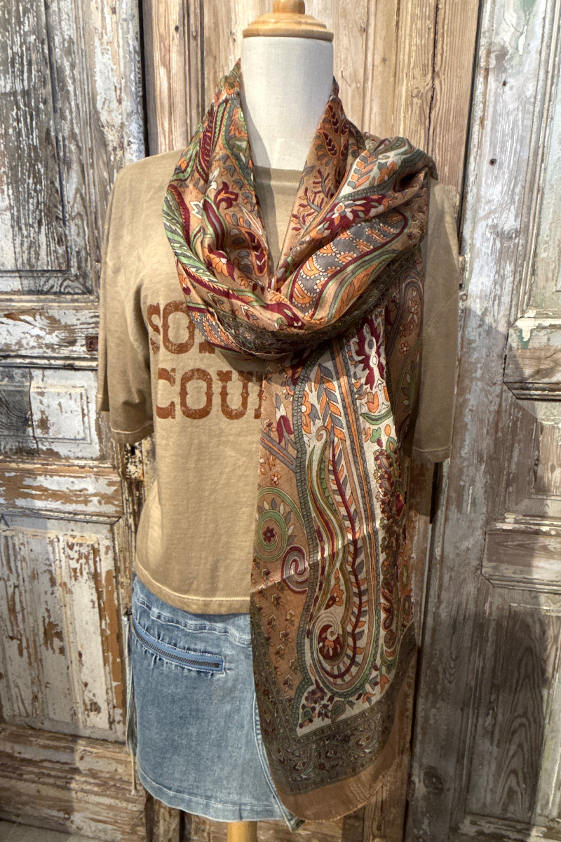 Trestles Clothing Company silk boho scarf with vibrant paisley print in earthy tones draped on a mannequin